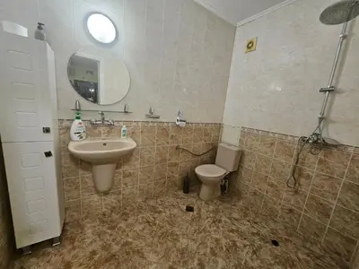 a bathroom with a sink and a toilet and a mirror at Стая за двама в град Бургас in Burgas City