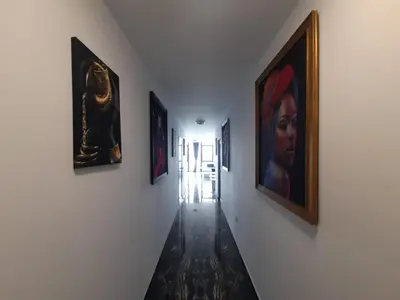 a hallway with paintings on the walls of a room at Luxe 1 Monte Carlo Suite in Obzor