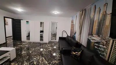 a living room with a black couch and a marble floor at Luxe 1 Dubai Penthouse in Obzor