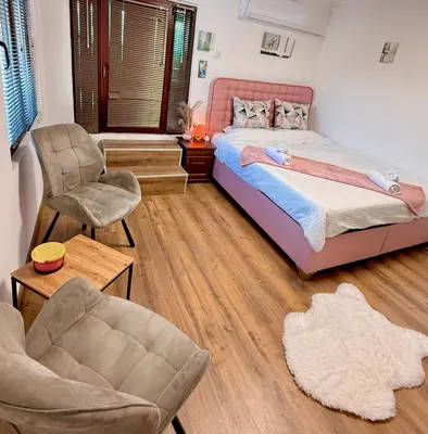 a bedroom with a bed and a chair at Вила Лонгоз