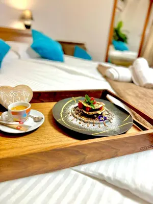 a tray with a plate of food and a cup of coffee at Вила Лонгоз