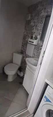 a bathroom with a toilet and a sink at Студио за двама в центъра на град Бургас in Burgas City