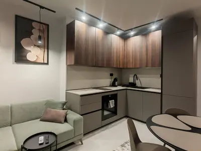 a kitchen and living room with a couch and a table at Апартамент Александровска in Burgas City