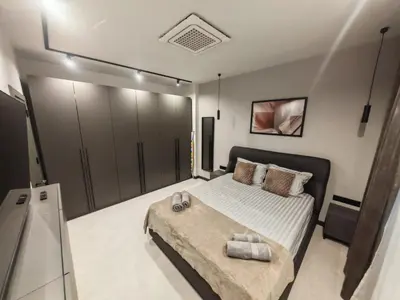 a bedroom with a bed and a television in it at Апартамент Александровска in Burgas City