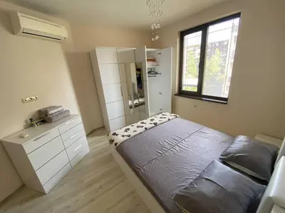 a bedroom with a bed and a shower in it at Апартамент в затворен комплекс Артур гр Свети Влас in Sveti Vlas