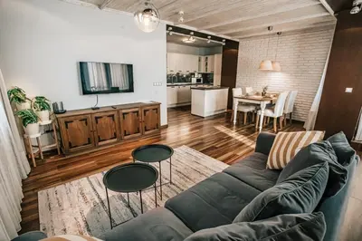 a living room with a couch and a kitchen at Desing Flat n2 Port - Designer - Own Parking - Streaming - 2 baths - Wash&Dry in Burgas City