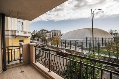 a balcony with a view of a building with a dome at Desing Flat n2 Port - Designer - Own Parking - Streaming - 2 baths - Wash&Dry in Burgas City