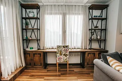 a living room with a desk and a chair at Desing Flat n2 Port - Designer - Own Parking - Streaming - 2 baths - Wash&Dry in Burgas City