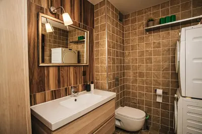 a bathroom with a sink and a toilet and a mirror at Desing Flat n2 Port - Designer - Own Parking - Streaming - 2 baths - Wash&Dry in Burgas City