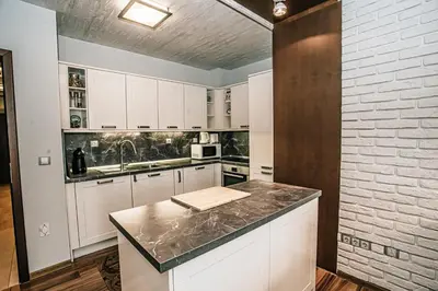 a kitchen with white cabinets and a counter top at Desing Flat n2 Port - Designer - Own Parking - Streaming - 2 baths - Wash&Dry in Burgas City
