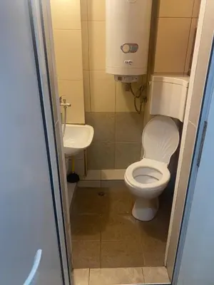 a small bathroom with a toilet and a sink at Стая радецки in Varna City