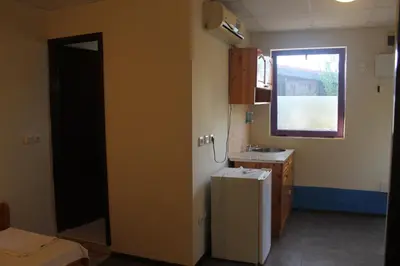 a small kitchen with a sink and a refrigerator at Complex Exotica in Lozenets