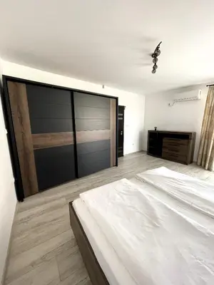 a bedroom with a large bed and a large sliding glass door at Velaria Centre Apartment in Burgas City
