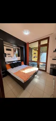 a bedroom with a large bed and a window at Siana3 in Sveti Vlas