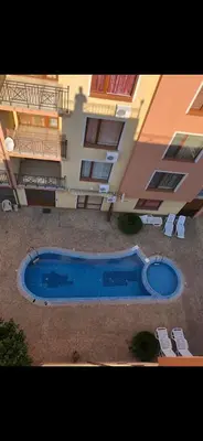 a large blue swimming pool in front of a building at Siana3 in Sveti Vlas