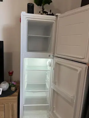 an empty refrigerator with its door open in a room at Siana3 in Sveti Vlas
