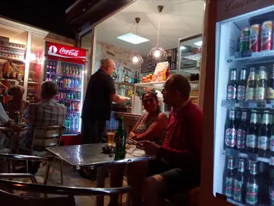 a group of people sitting at a table in a bar at Mechta Family Hotel in Obzor