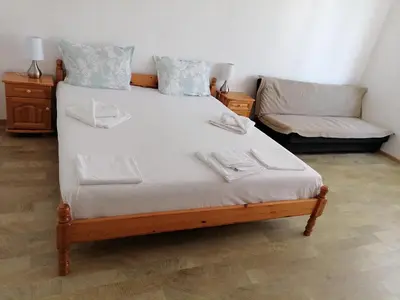 a bedroom with a large bed and a couch at Mechta Family Hotel in Obzor