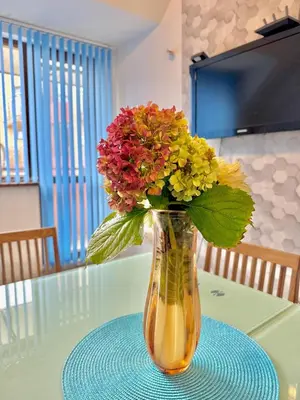 a vase filled with flowers sitting on a table at Galateya in Varna City