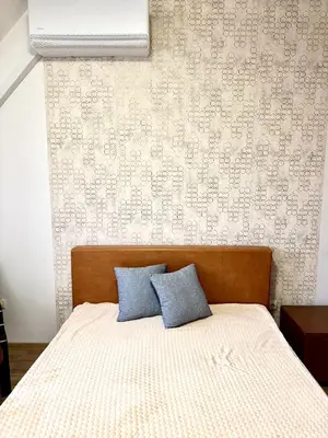 a bedroom with a bed with two blue pillows at Galateya in Varna City