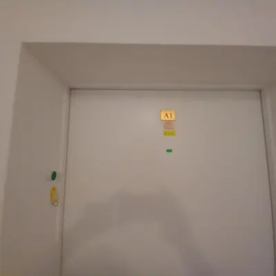 a white door with an exit sign on it at Home Comfort in Sunny Beach