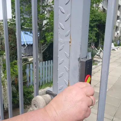 a persons hand holding a piece of a metal fence at Home Comfort in Sunny Beach