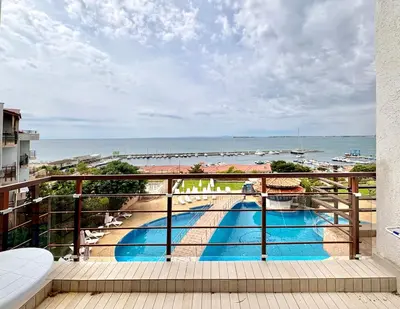 a balcony with a view of a swimming pool and the ocean at Sveti Vlas Marina Beach Apartment - Diamond Apart Complex in Sveti Vlas