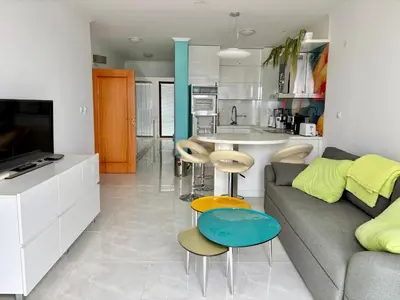 a living room with a couch and a kitchen at Sveti Vlas Marina Beach Apartment - Diamond Apart Complex in Sveti Vlas