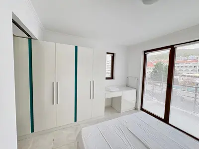 a bathroom with white cabinets and a window at Sveti Vlas Marina Beach Apartment - Diamond Apart Complex in Sveti Vlas