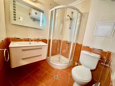 a bathroom with a shower and a toilet and a sink at Sveti Vlas Marina Beach Apartment - Diamond Apart Complex in Sveti Vlas