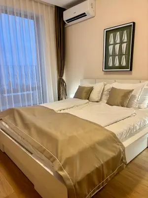 a large bed in a room with a window at Luxury in Sveti Vlas