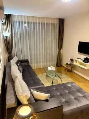 a living room with a couch and a glass table at Luxury in Sveti Vlas