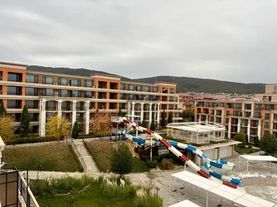 a large building with a water slide in front of it at Luxury Premier Fort Beach in Sveti Vlas