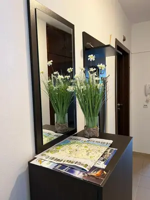 a display case with a mirror and flowers on it at Home for you, 2-bedroom apartment in Burgas City