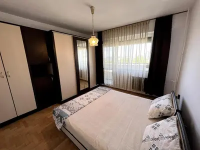 a bedroom with a large bed and a window at Home for you, 2-bedroom apartment in Burgas City