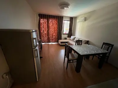a living room with a table and a couch at Camping Gradina Sunny Bay Appartment in Chernomorets