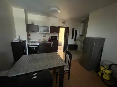 a small kitchen with a table and a refrigerator at Camping Gradina Sunny Bay Appartment in Chernomorets