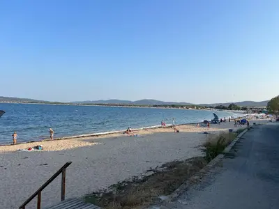 a group of people on a beach near the water at Camping Gradina Sunny Bay Appartment in Chernomorets