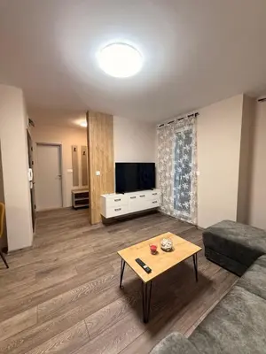 a living room with a couch and a coffee table at Danny Apartment Welcomes You in Burgas City
