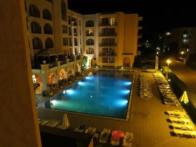 an overhead view of a swimming pool at night at PALAZZO FAMILY SUITE Sunny beach in Sunny Beach