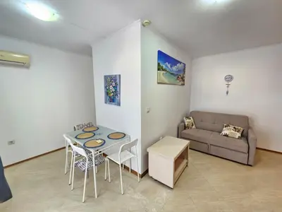 a living room with a couch and a table at PALAZZO FAMILY SUITE Sunny beach in Sunny Beach