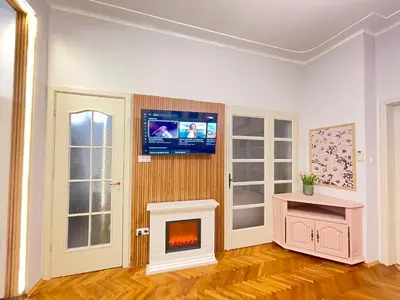 a living room with a fireplace and a tv at 'Tide Frame' Apartment - Big, Super Central, 2 bathrooms in Burgas City