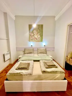 two beds in a room with a painting on the wall at 'Tide Frame' Apartment - Big, Super Central, 2 bathrooms in Burgas City