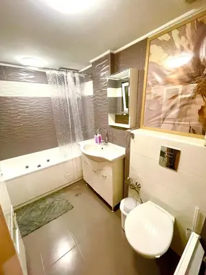 a small bathroom with a toilet and a sink at 'Tide Frame' Apartment - Big, Super Central, 2 bathrooms in Burgas City