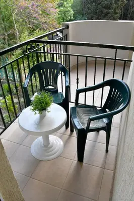 two chairs and a table on a balcony at Family нouse -Нotel Asai in Ravda