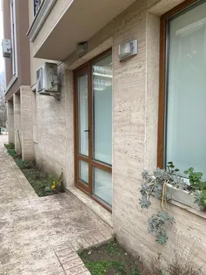 a building with a glass door on the side of it at Balkan Breeze 7 - Rey&Mar Apartaments in Sunny Beach