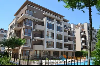 an apartment building with a fence in front of it at Balkan Breeze 7 - Rey&Mar Apartaments in Sunny Beach