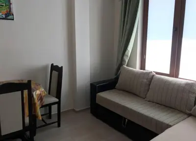 a living room with a couch and a chair and a window at Balkan Breeze 7 - Rey&Mar Apartaments in Sunny Beach