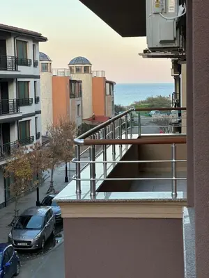 a balcony of a building with a view of the ocean at Apartment near the sea in Pomorie