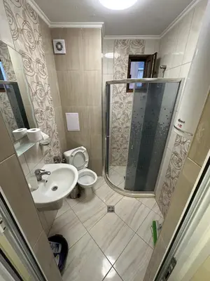 a bathroom with a shower and a toilet and a sink at Apartment near the sea in Pomorie